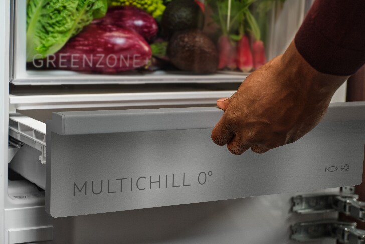 Man pulling Multichill drawer inside fridge.