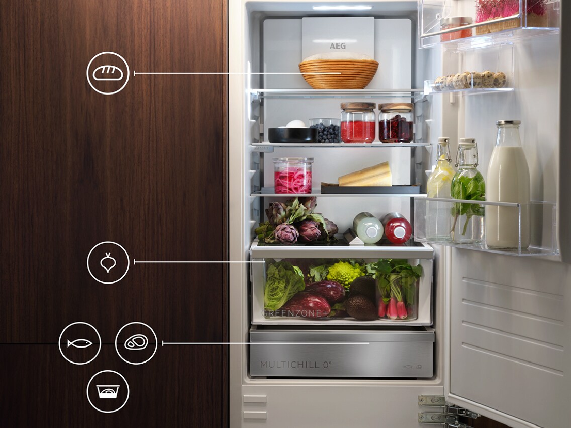 Open fridge with veggies and other goodies inside.