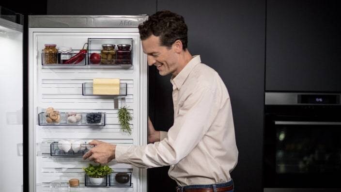 Man opening fridge