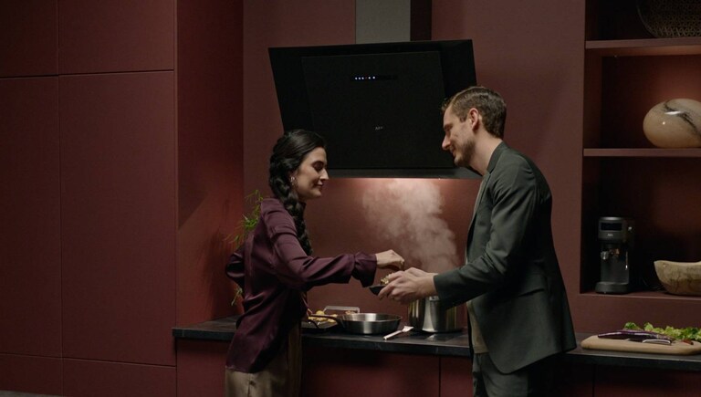 Man and woman in a modern kitchen.